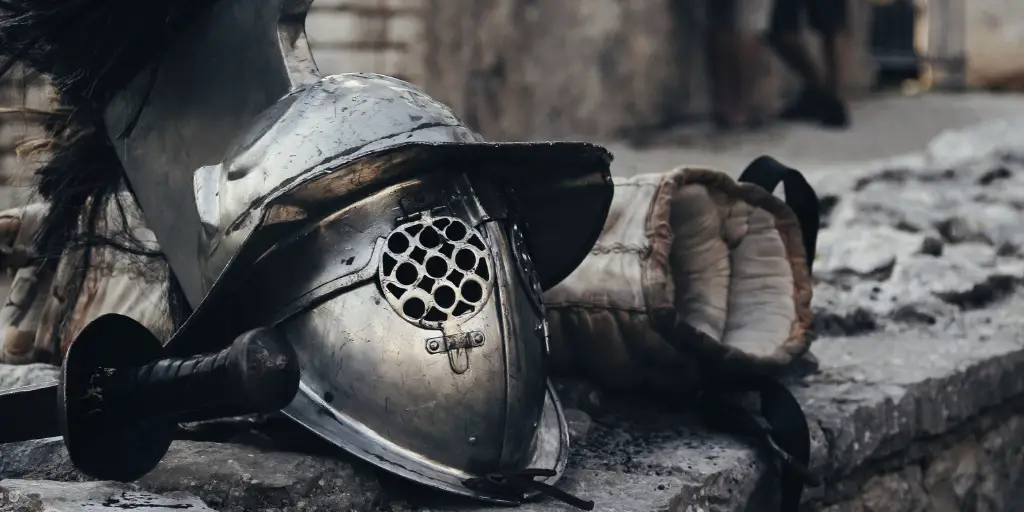 Heavy metal armor and a sword lies on a stone ledge.