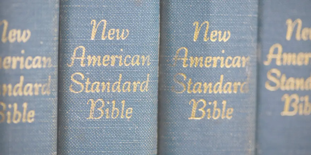 Four New American Standard Bibles stand side by side against each other.